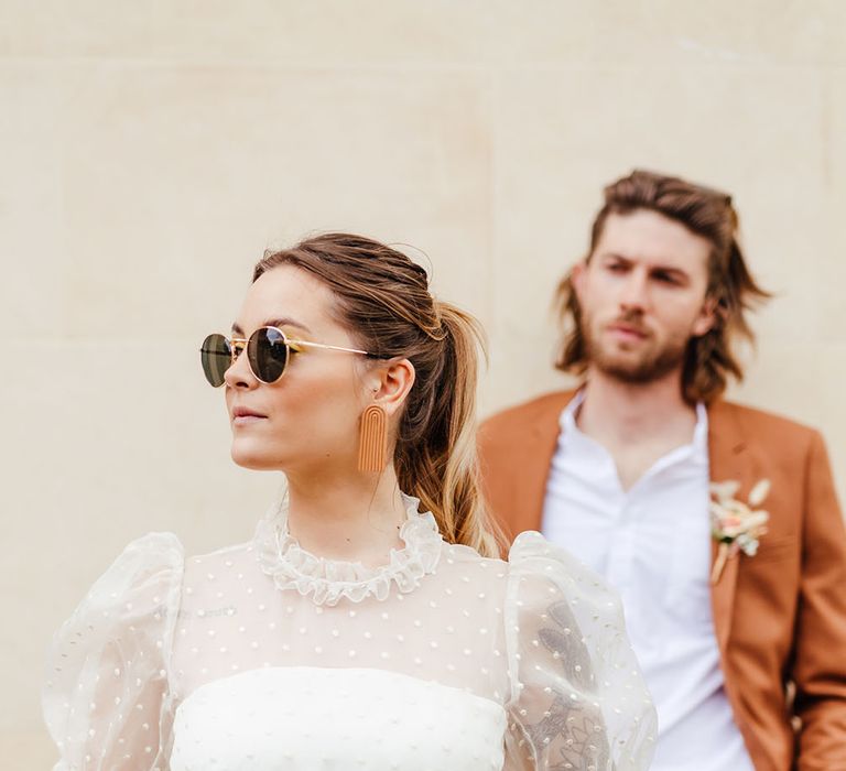 Bride in polka dot short wedding dress and retro sunglasses 