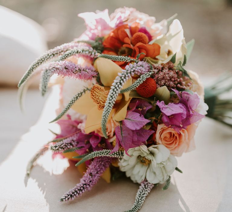 Multi coloured mixed flower wedding bouquet with roses and veronica for enchanted forest wedding in Italy