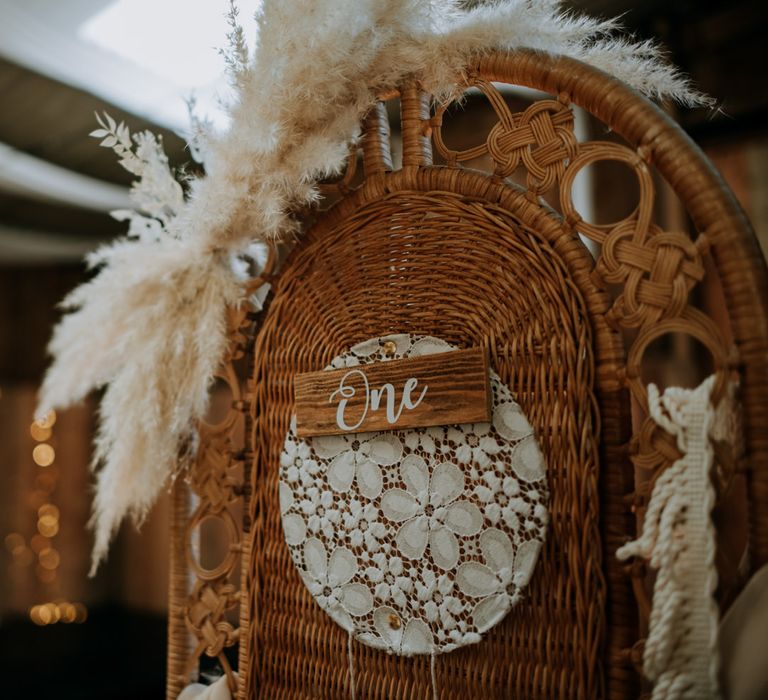 Wicker, lace, wood and pampas grass bohemian wedding decor 