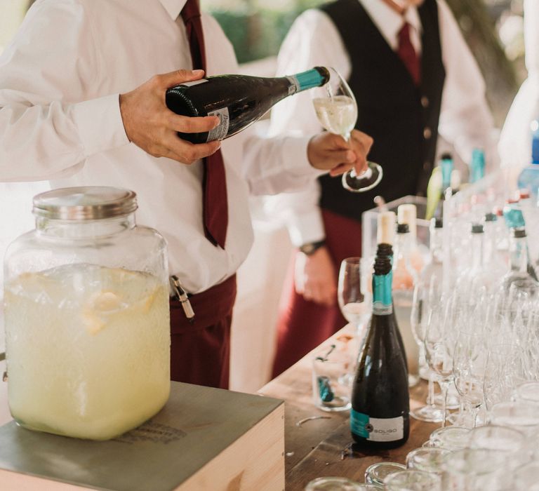 Waiter pours wine at wedding reception party in Italy