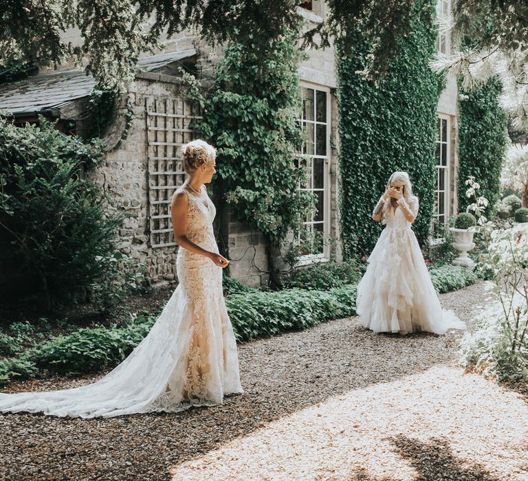 Two brides engage in a 'first look' before their wedding ceremony. 