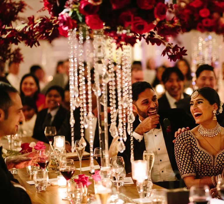 Bride & groom laugh during wedding reception 