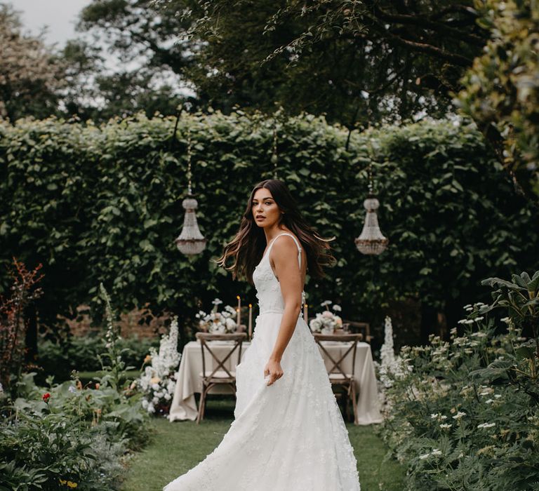 Bride in an appliqué wedding dress with fitted bodice and thin straps from the new Suzanne Neville Nova 2022 bridal collection