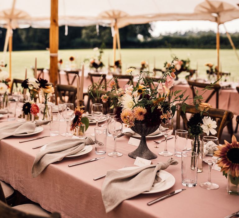 Dusky pink wedding table with florals, napkins and glassware for marquee garden wedding reception in Cornwall