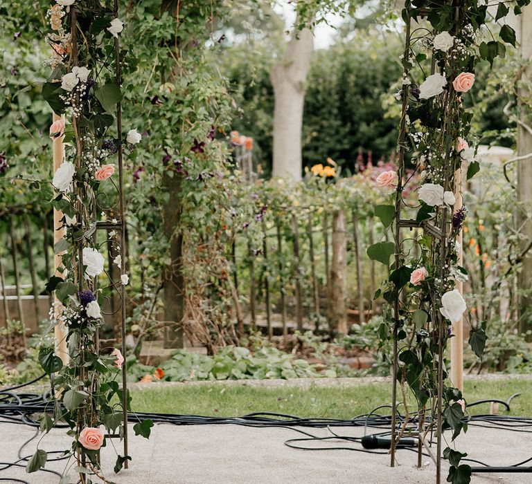 Floral archway for Christian wedding in marquee in family garden