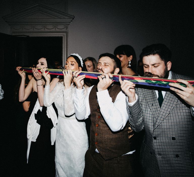 Bride does shot ski with groom and guests