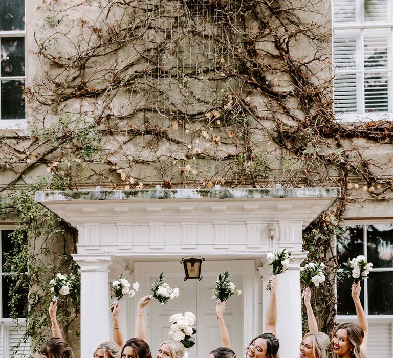 Bridal party portrait with bride in a strapless wedding dress and bridesmaids in champagne gold bridesmaid dresses 