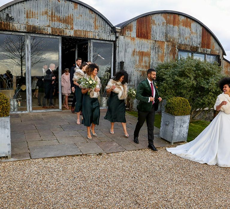 Bride stands outside the Stone Barn for rustic wedding day