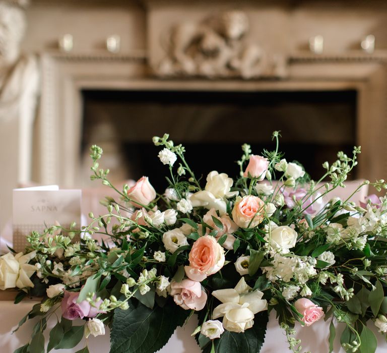 Floral bouquets line tables on wedding day