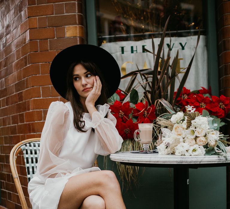 Bride in a short Story Of My Dress wedding dress and black Fedora hat with Black shoes with pearl strap