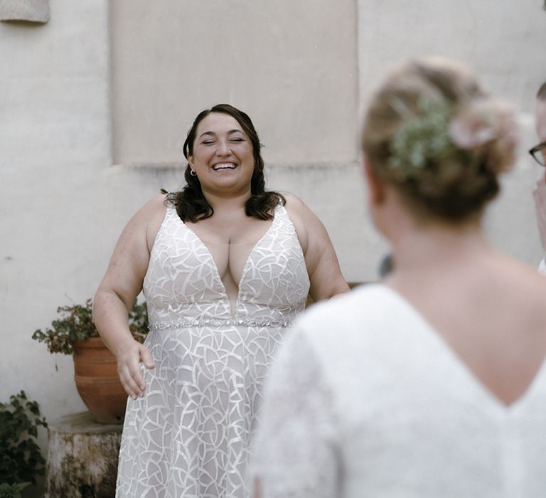 Brides smile as they see each other for the first time at Barcelona wedding 