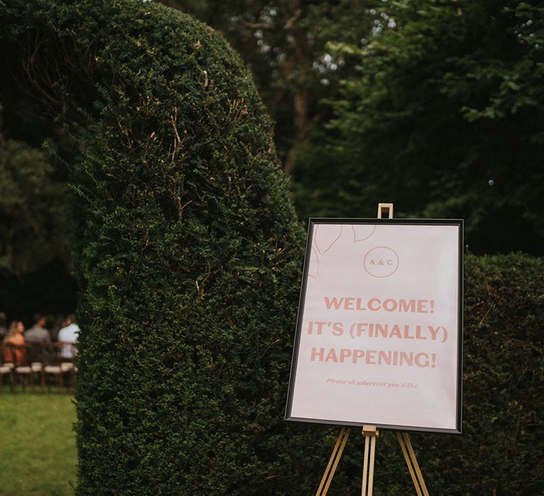 Peachy pink welcome wedding sign to outdoor country house wedding at Colehayes Park