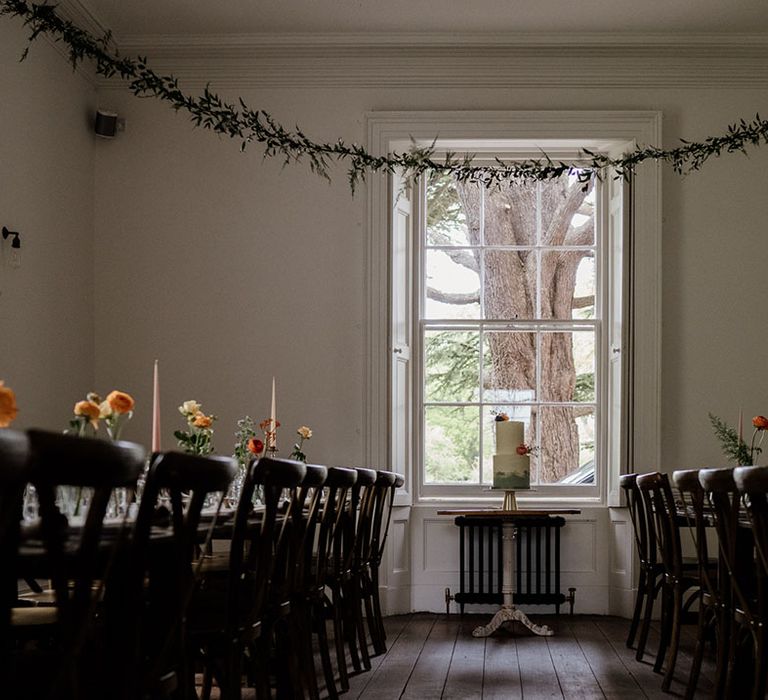 Reception room at Aswarby Rectory wedding venue decorated with colourful candles and foliage 