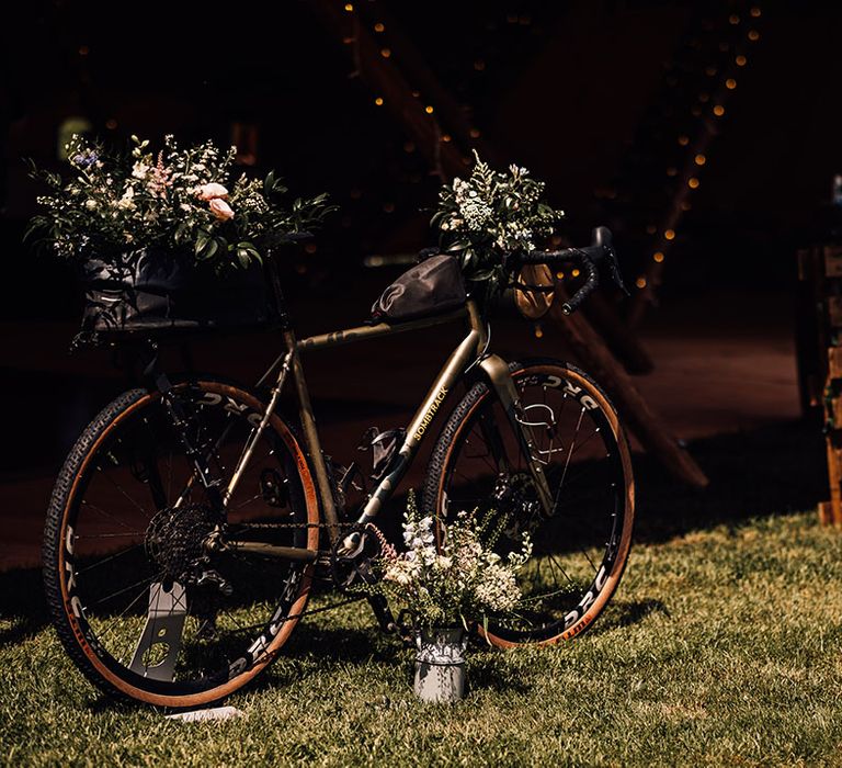 Bike decorated with wedding flowers and wooden pallet order of the day sign 