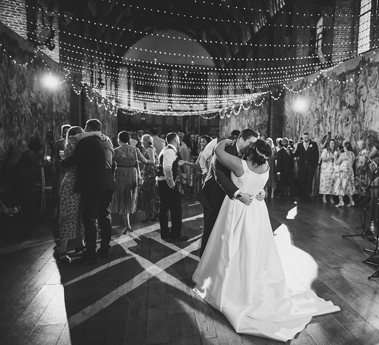 Bride and groom share an intimate dance together while the live wedding band plays