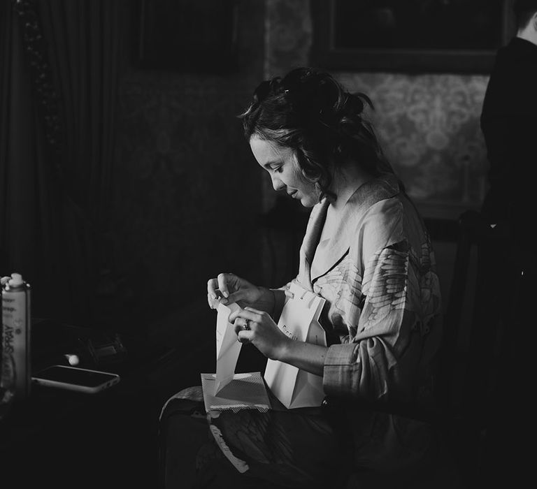 Bride gets ready on the morning of her wedding day in black & white image 