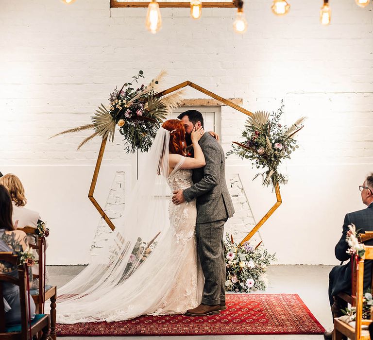 Bride and groom share their first kiss as a married couple 