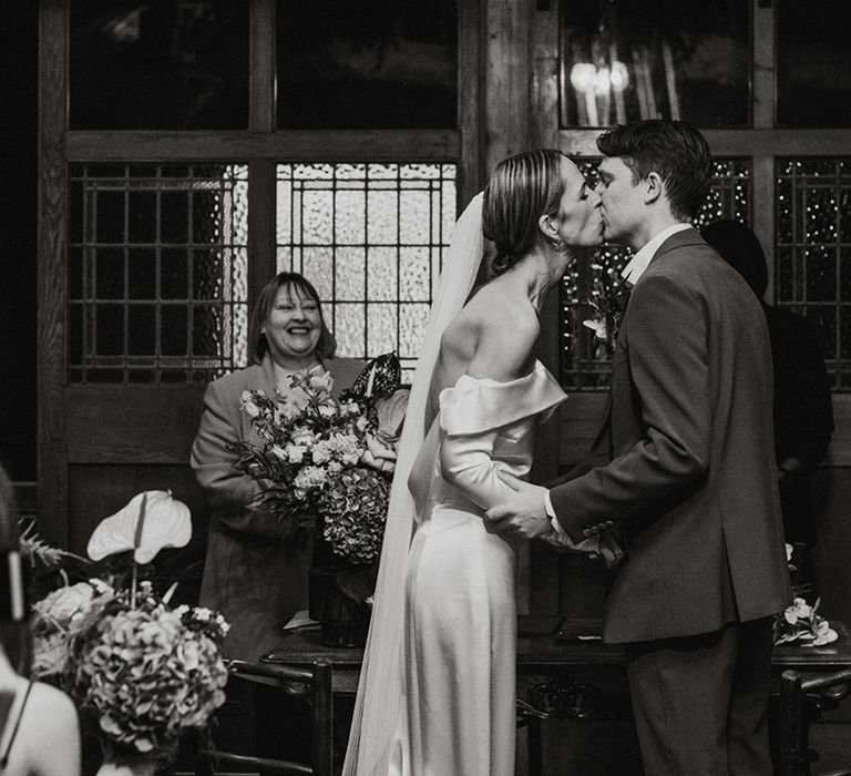 Bride and groom share their first kiss as a married couple