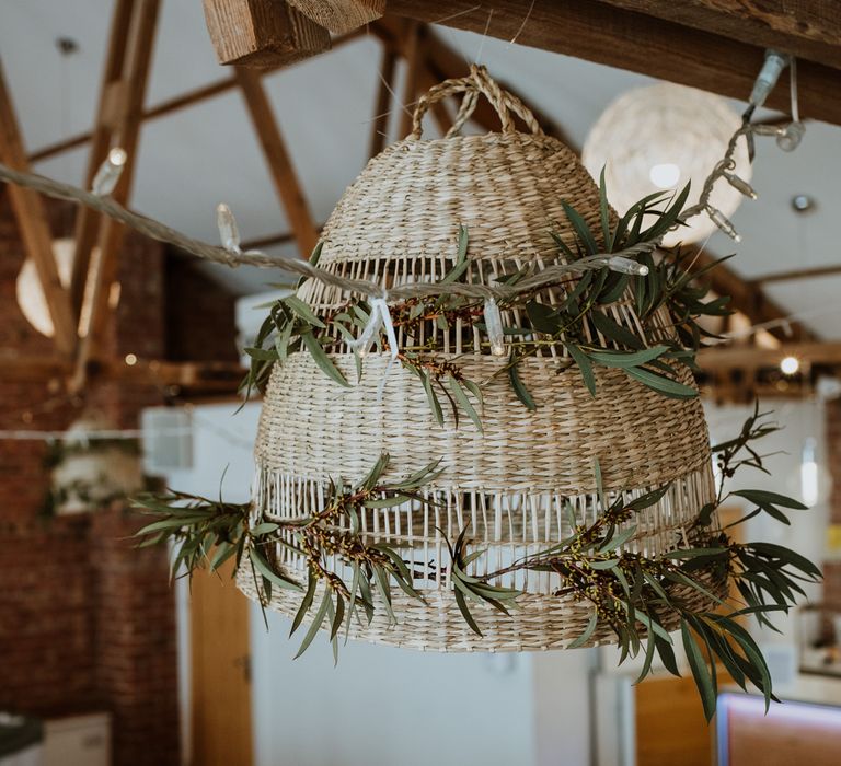 Large hanging wicker decor with foliage decorations and fairy lights