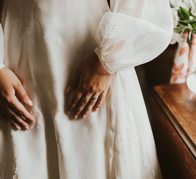 Bride in a delicate Phillipa Lepley wedding dress with a sheer balloon sleeve overlay