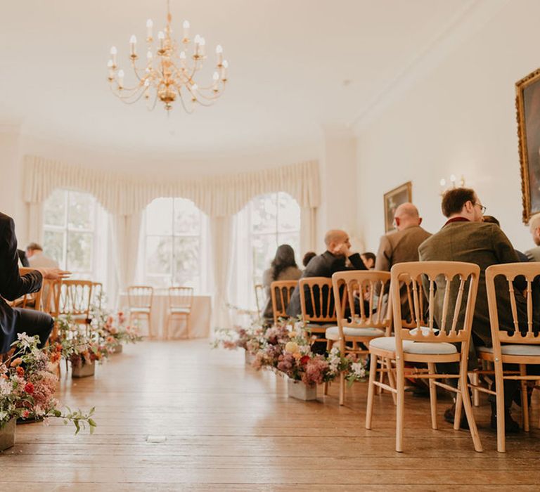 Bright floral arrangements line the aisle of Cambridge Cottage at Kew Gardens 