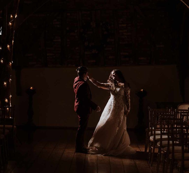 First dance wedding photo at Bassmead Manor Barns wedding venue with festoon lighting 