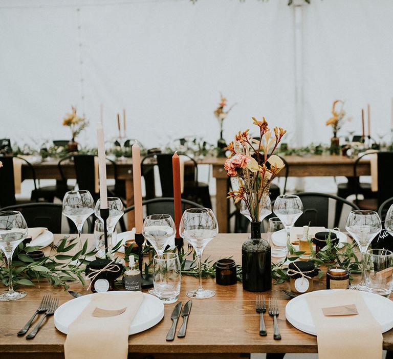 greenery table runner and black wedding decor with wildflowers in vases 