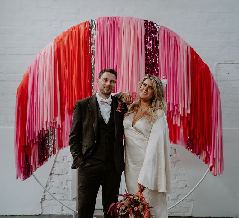 Pink wedding theme with pink, red, and silver streamer decorations for industrial wedding 