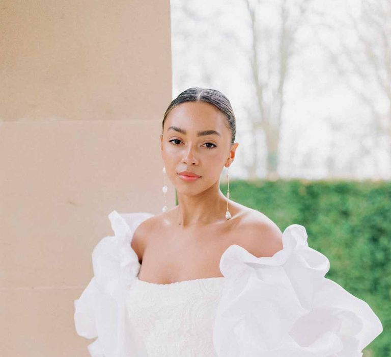 strapless lace wedding dress with detachable puff sleeves and black satin bridal gloves at Settrington Orangery 