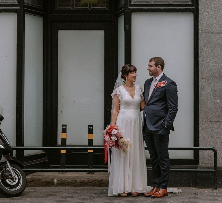 The Bedford city wedding venue with bride and groom posing for couple portrait 