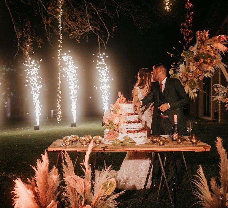 bride and groom cutting the semi naked wedding cake at tenuta il cigno wedding 