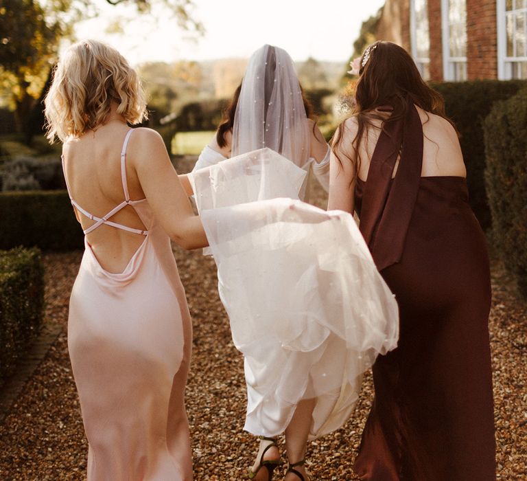 Bride walking with the bridesmaids on the way to the wedding venue 