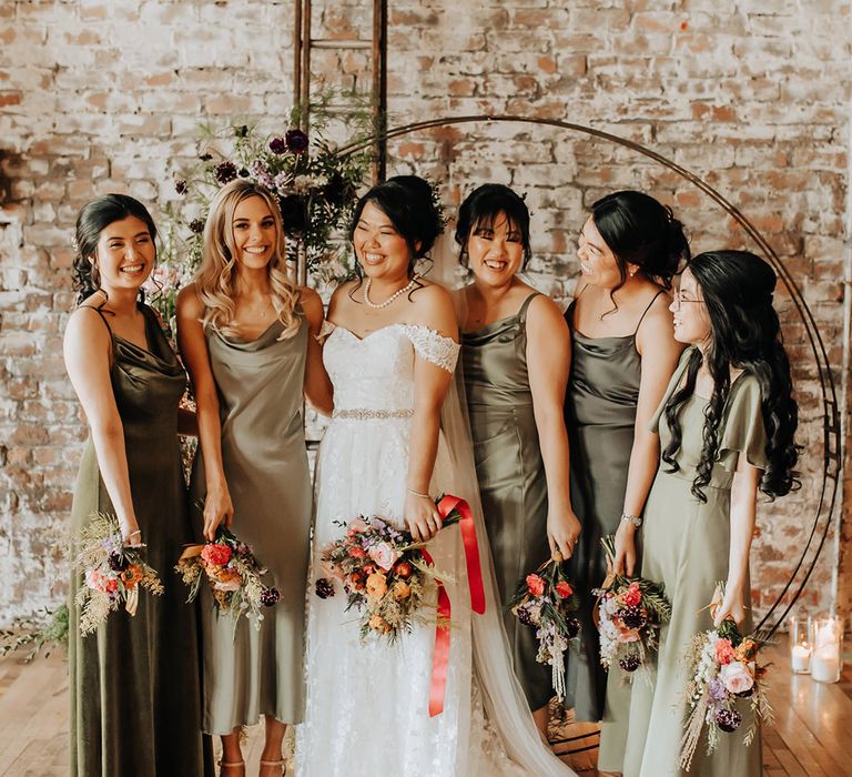 Bridesmaids in olive and sage green mismatched bridesmaid dresses for Liverpool wedding 