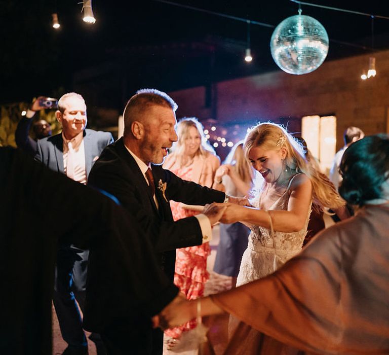 Father daughter dance at the wedding reception with a disco ball 