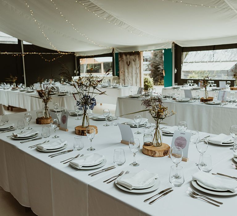 Wilde Lodge with minimalist wedding tables with white tablecloth and wedding flowers in glass vases 