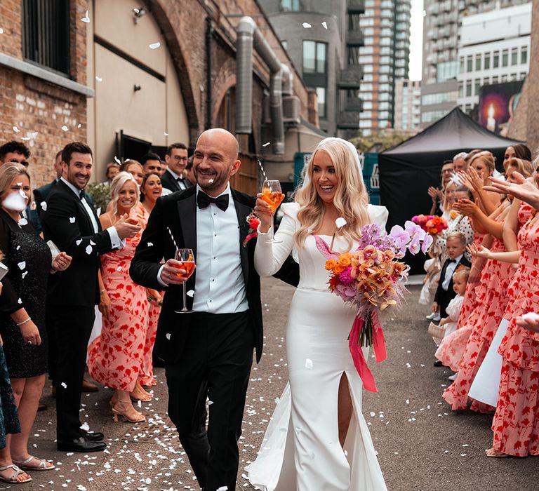 Black tie London wedding at Shoreditch Studios with confetti moment for bride and groom with Aperol Spritz 