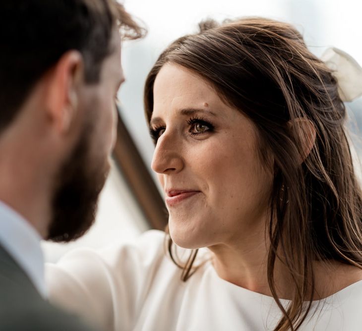 Bride gazes lovingly at new husband