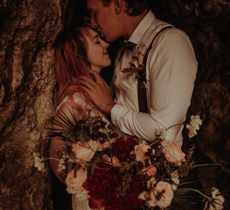 Bride holding a red and white wedding bouquet