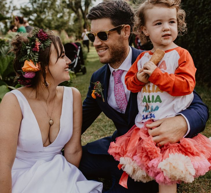 Bride, groom and daughter at rainbow wedding 