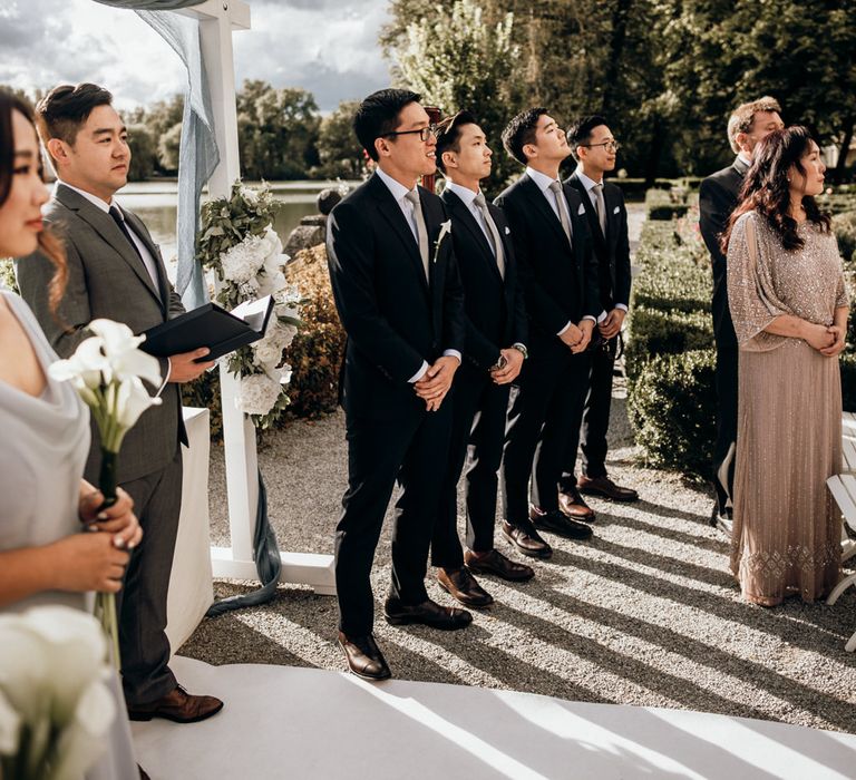 Groom and groomsmen standing at the altar waiting for the bride to arrive 