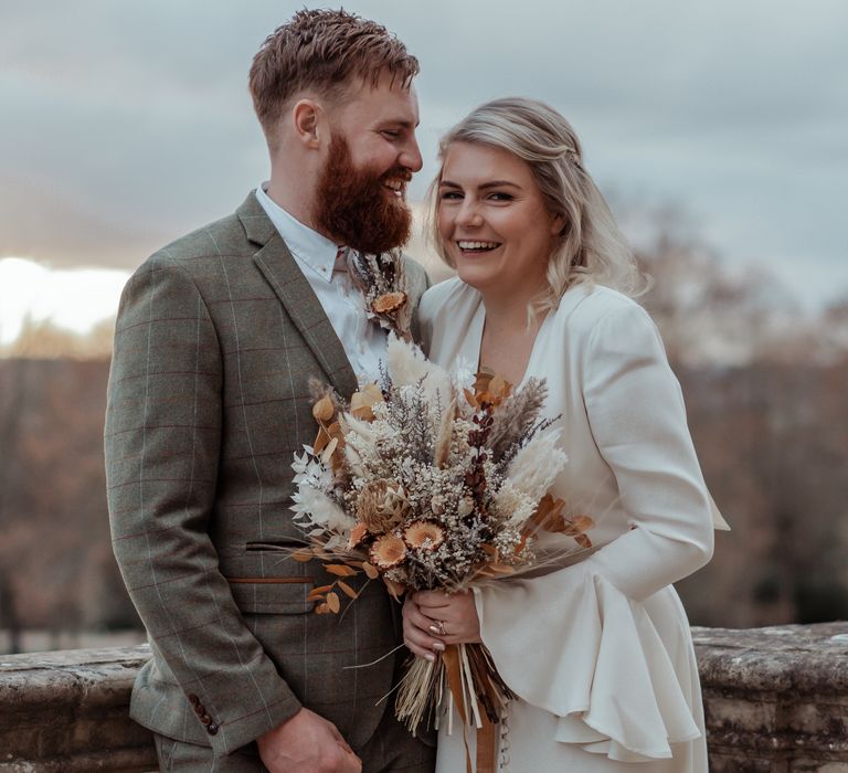 Bride & groom pose on the balcony of Cliveden House