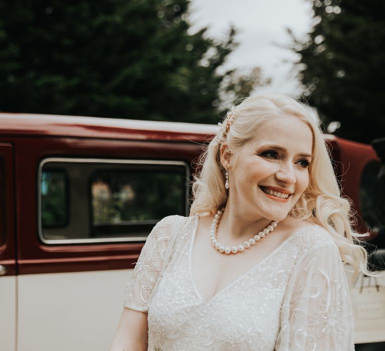 Bride smiles on wedding day holding bouquet 