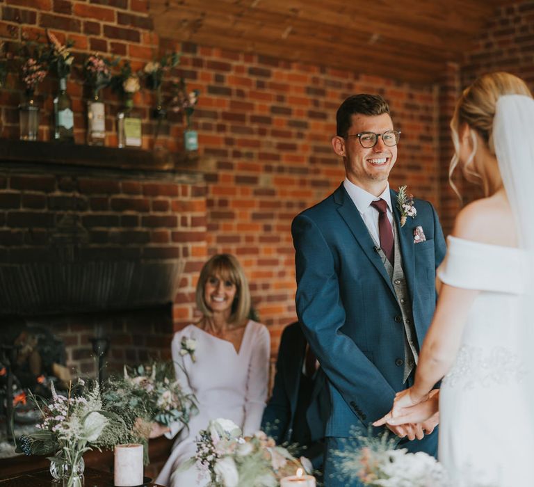 Groom smiles during wedding ceremony