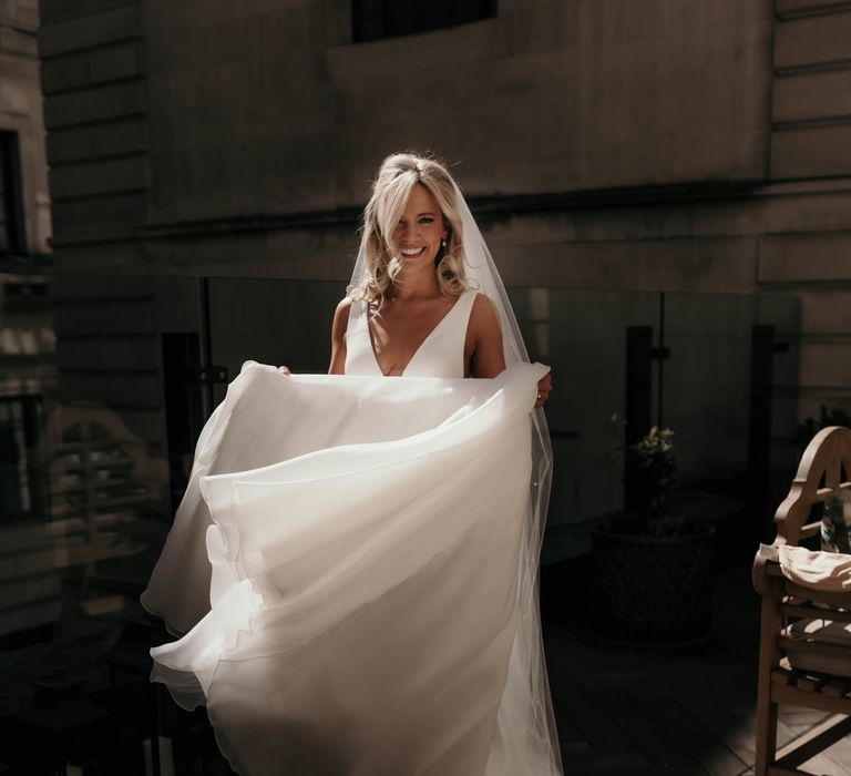 Bride lifts her gown on the morning of her wedding day