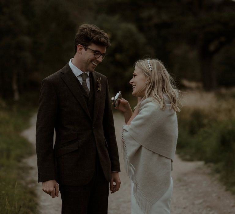 Bride wears shawl over shoulders on the day of her wedding