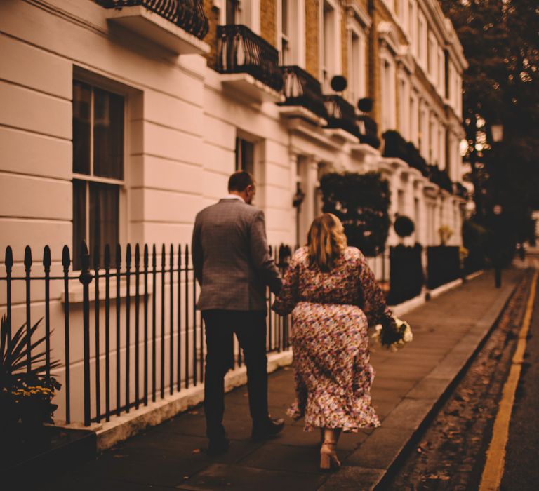 Bride & groom walk through the streets of Chelsea on Autumnal day