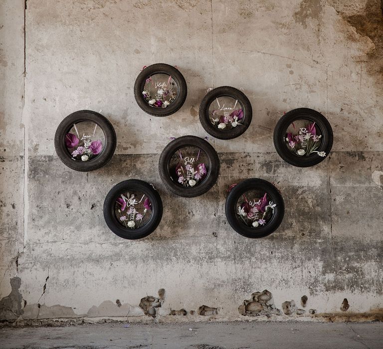 Tyre wedding seating chart with acrylic signs and purple flowers 