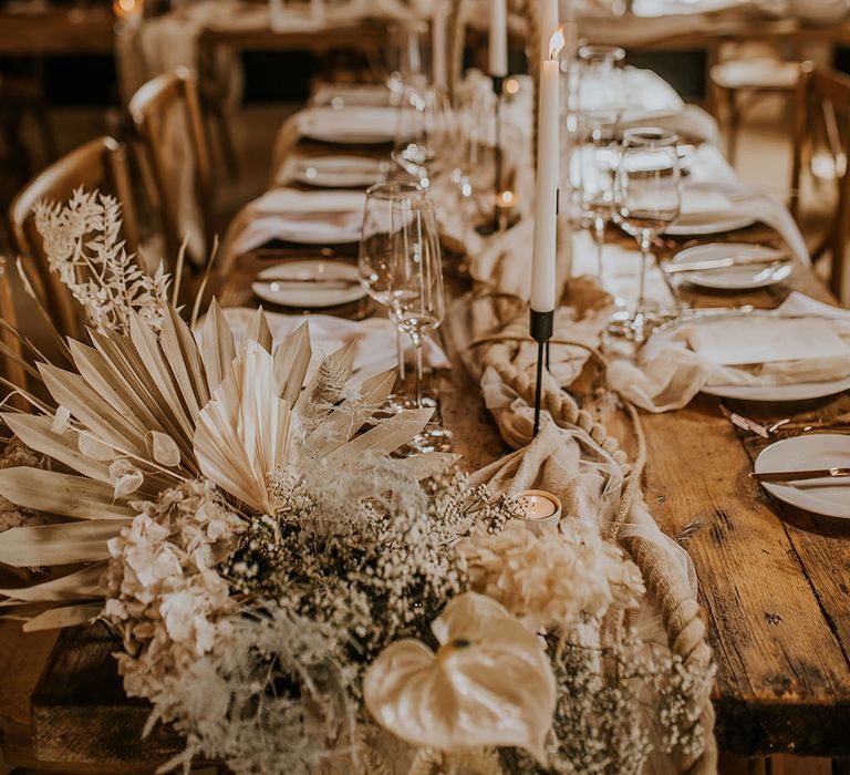 Neutral wedding table decor with dried palm leaves, Anthuriums and ropes