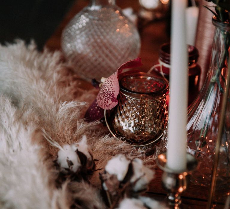 Romantic tablescape details with tapered candles, pampas grass and gold tea light holders