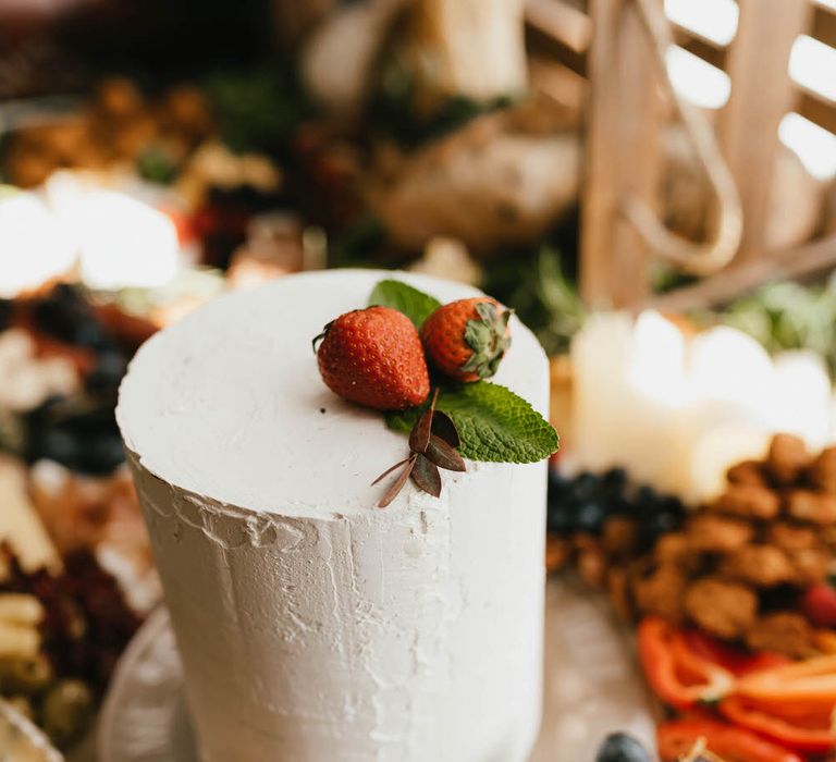 One tier small white wedding cake with strawberry embellishment